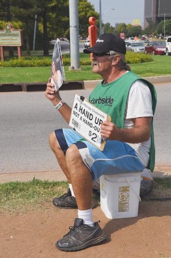 Calvin McCraw most days can be found selling the Curbside Chronicle from the median on N. Classen Boulivard at the intersection of N.W Expressway, 9-30-15. - MARK HANCOCK