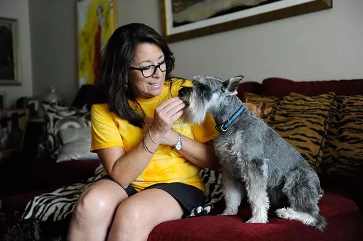 Cherokee Ballard feeds "Dexter Doodle Bug Daddy Boy" at treat at her home, Thursday, Oct. 22, 2015. Ballard adopted "Dexter Doodle Bug Daddy Boy" from the Bella Foundation. - GARETT FISBECK