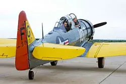Front, owner and Pilot of the 1940's AT-6, Britton Lee and rear, pilot Tom Hennebry land at Sundance Airpark and will perform in the air show.Photo/Shannon Cornman - SHANNON CORNMAN