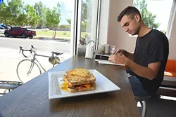 The Sweet Jesus sandwich on the window counter at Elemental Coffee with patron, Brett Haynie doing his thing behind. mh