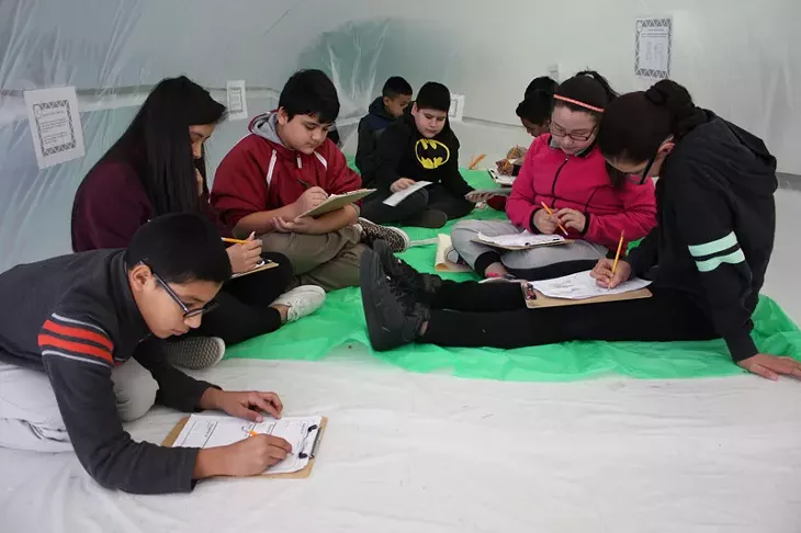 Sixth grade students work through an assignment inside a biosphere created by their teacher, Marci Vaughan. - LAURA EASTES
