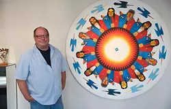 Eric Oesch, deputy director of Red Earth, with Native American artwork by Commanche artist, Rance Hood called "Peyote Men", inside their facility located in the Santa Fe Plaza in Downtown OKC, 10-2-2015. - MARK HANCOCK