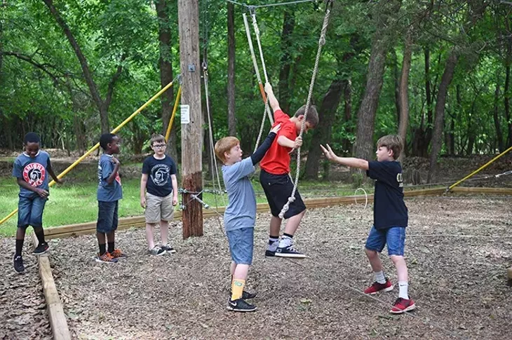 Kids from Crossings Christian School play on a ropes course at Camp Dakani recently. mh