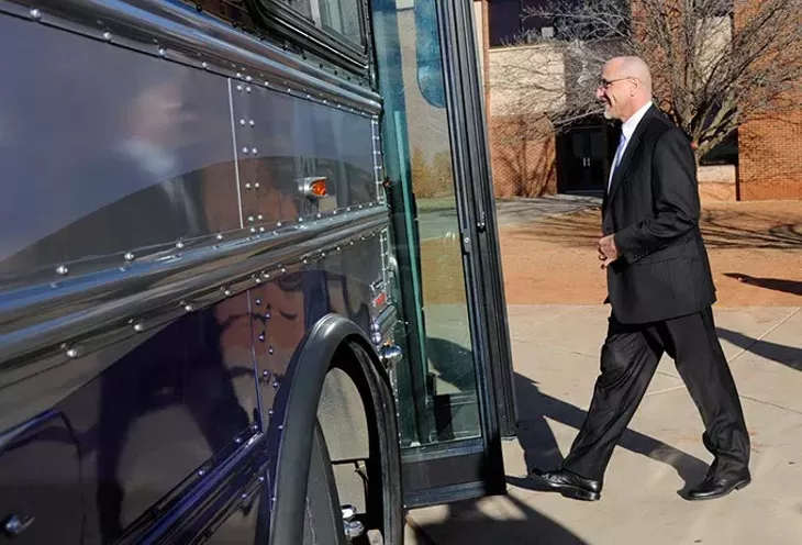 Oklahoma City Superintendent Rob Neu gets on a bus at Centennial High School in Oklahoma City, Wednesday, Jan. 28, 2015. Legislators were given tours of F schools in the Oklahoma City public school system. - GARETT FISBECK