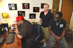 Lamar "L-Smooth" Mensa, right, listens to new tracks he has recently recorded with his producer, CAP, left, and good friend and manager, Rodney Dawson at Inferno Factory . mh