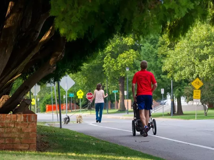 Residents enjoy a stroll or jog on the quiet streets of Crown Heights on a summer's eve. Photo/Shnnon Cornman - SHNNON CORNMAN