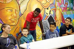 Sgt. T.G. Childs listens to members the FACT program during a lesson at Hathaway Recreation Center in Oklahoma City, Tuesday, Sept. 15, 2015. - GARETT FISBECK