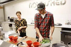 Lindsey Riddle and Jamie Conway prep kale at Nourished Food Co. in Oklahoma City. (Garett Fisbeck)