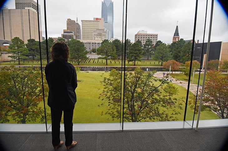 Mary Anne Eckstein at the new, large Oklahoma City National Memorial viewing window, from inside the Memorial Museum where she serves as Director of Media, 10-23-15. - MARK HANCOCK