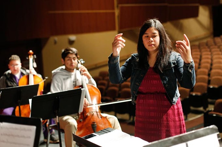 Samantha Sy leads an orchestra class at NW Classen High School in Oklahoma City, Thursday, May 7, 2015. - GARETT FISBECK