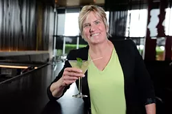 Margaret Holloway poses for a photo with her signature drink, The Gecko Fizz, at Cafe 501 in Oklahoma City, Tuesday, May 26, 2015. - GARETT FISBECK