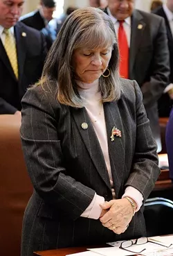 Rep. Sally Kern prays during Gov. Mary Fallin's State of the State address at the Oklahoma State Capitol in Oklahoma City, Monday, Feb. 2, 2015. - GARETT FISBECK