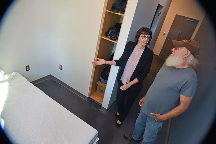 Larry Murray and Kim Woods, deputy director of The Homeless Alliance, discuss the benifits of his new home in the West Town Apartments, on the property of the WestTown Homeless Resource Campus in Oklahoma City, 9-21-15. - MARK HANCOCK