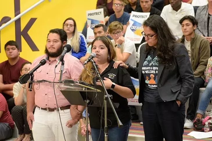 DACA recipients Alejandro Raigoza Munoz left and Judith Huerta right comfort Brisa Ledezma as she speaks during a demonstration to defend DACA at Santa Fe South High School last week. (Garett Fisbeck)