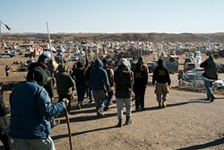 Hundreds of campers at North Dakota&#146;s Standing Rock Indian Reservation participate in a prayer ceremony. Indigenous tribes from across North America show solidarity with Standing Rock Sioux Tribe&#146;s struggle to protect its natural resources and sacred land. (Wade Dunstan / for Oklahoma Gazette)