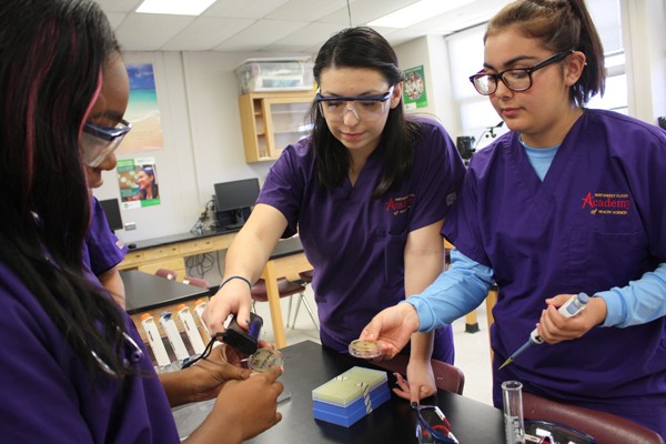 from left Marilu Cardenas and Cassidy Lopez perform a bio lab at Northwest Classen High School. They are part of the first graduating class of the school&#146;s Academy of Health Sciences. | Photo Laura Eastes