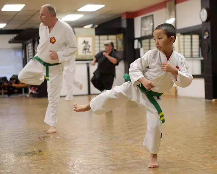 Ethan Nguyen, 7, and Robert Walker, 60, during a karate class at Okinawa Karate School, Thursday, Jan. 5, 2017. - GARETT FISBECK