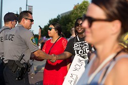 Oklahoma City Black Lives Matter marchers shake hands with Oklahoma City Police officers during the July 10 rally in Bricktown. (Emmy Verdin)