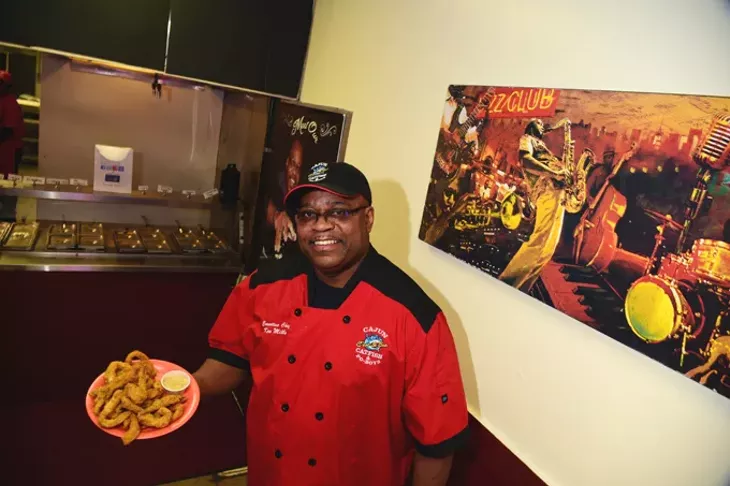 C'est Si Bon owner, Ken Mills, with a plate of fresh fried catfish. mh