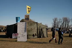 A centralized Standing Rock Sioux Tribe help tent and volunteer training sign at a camp near Dakota Access Pipeline development. (Wade Dunstan / for Oklahoma Gazette)