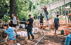 Volunteers raise a new hoop house to extend the growing season at CommonWealth Urban Farms of OKC. (Photo Bo Aptiz / provided)