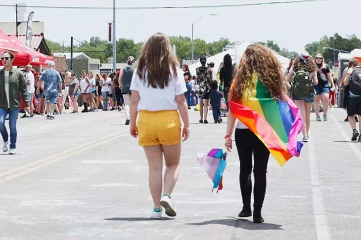 Pride flags of all kinds are one of the biggest parts of Pride festivals and parades. They are often carried, or worn around the neck like capes. (Cara Johnson).