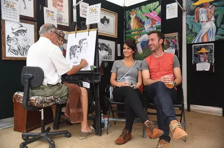 Kelly Killough of Kelly Killough Studios makes caricatures of Ayla Amonovic and Ryan Moore at the 2015 Paseo Arts Fest. mh