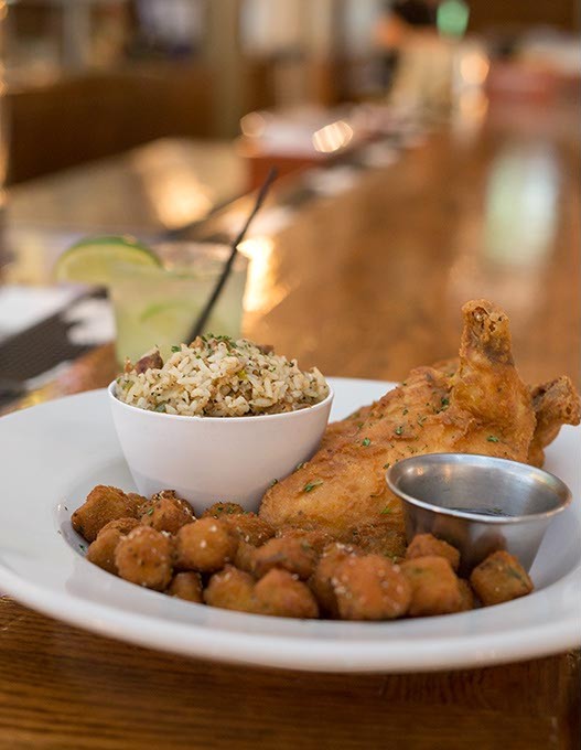 JAX Soul Kitchen serves Smoked Fried Chicken with Dirty Rice, Fried Okra and a Basil Brazilian cocktail on Monday, June 27, 2016 in Norman, Oklahoma. - EMMY VERDIN