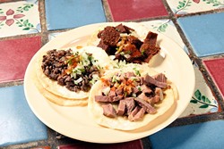 Azada, Milaneza, and Lengua tacos at Carnitas Michoacan in Edmond, Thursday, May 26, 2016. - GARETT FISBECK