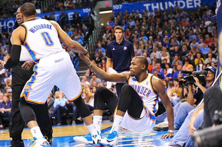 OKC Thunder player Russell Westbrook helps Kevin Durant up off the court after a tumble in this 2013 photo. | Photo Gazette / file