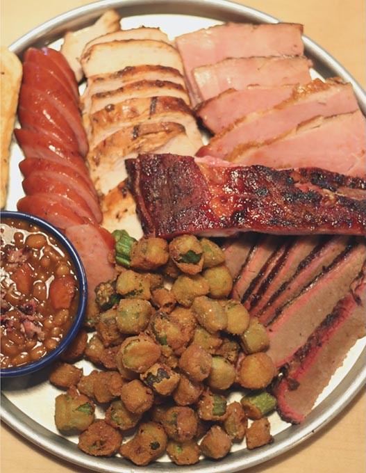 The Oklahoma Sampler at Swadley's BBQ. The dish features over a pound of meat including brisket, chicken, ham, sausage and rib as well as two sides. (Cara Johnson).