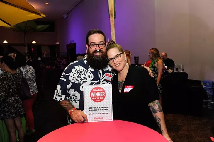 Jason and Tisha King show off their 23rd Street Body Piercing award for best place to get pierced or inked.