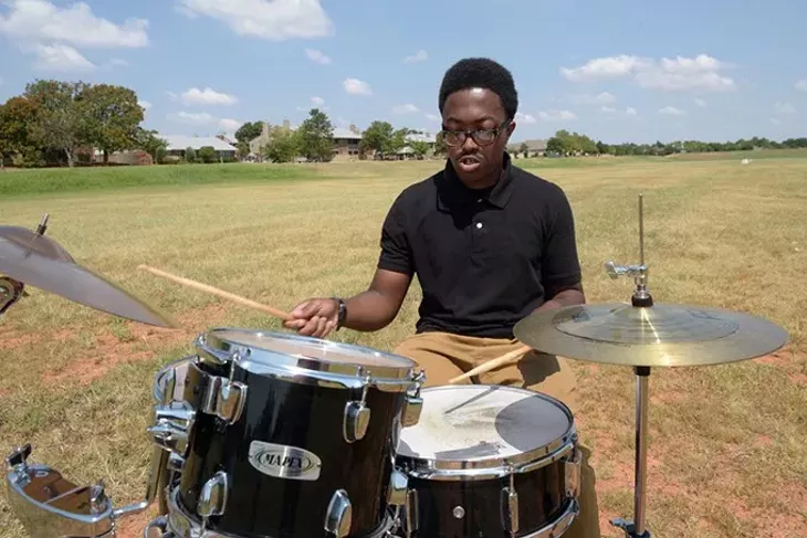 Zacharias Paris plays his drums in a spillway near his apartment. (Garett Fisbeck)