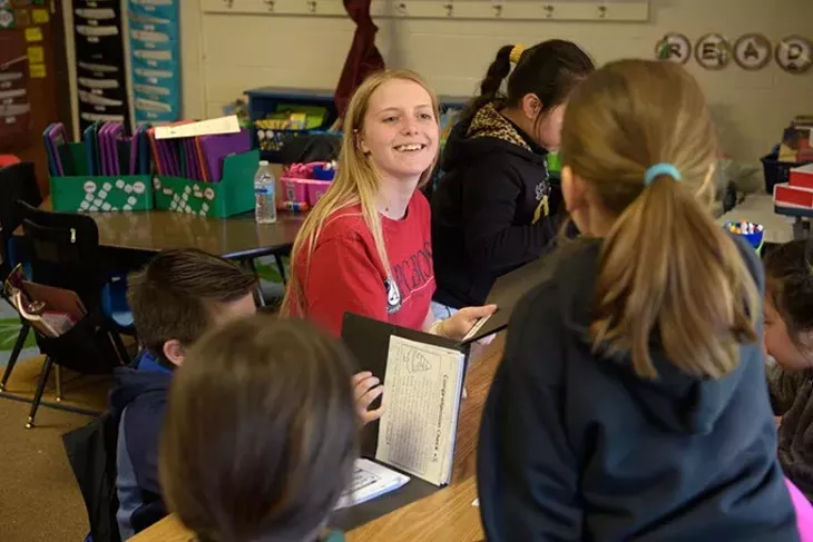 Abby Shelley, Americorps volunteer, works with children during an afterschool program at Hilldale Elementary, Thursday, April 6, 2017. - GARETT FISBECK