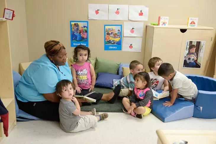 Danyale Murray reads to children at Kidzone Learning Center, an OKC childcare facility benefiting from a partnership with Sunbeam Family Services. | Photo Garrett Fisbeck