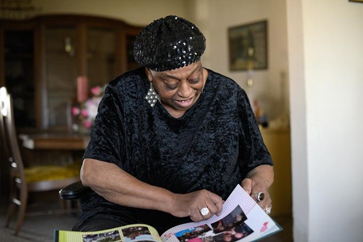 Miss Blues digs through old posters and photographs at her home in Oklahoma City, Tuesday, March 14, 2017. - GARETT FISBECK