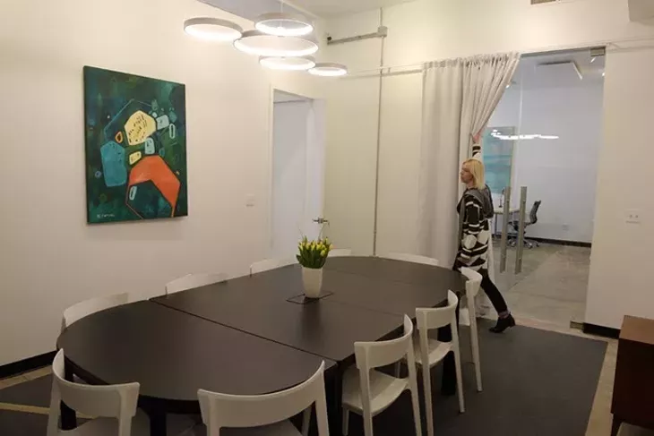 Erin Cooper shows off the conference room at Halcyon Works in the Paseo District (Garett Fisbeck)