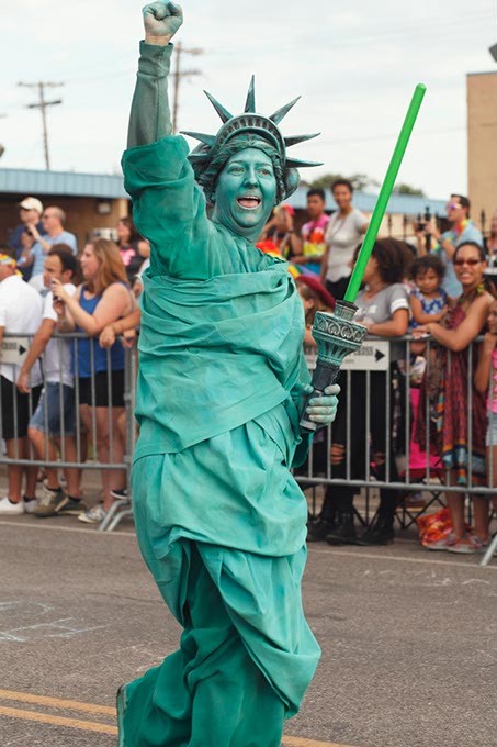 A participant dressed as Lady Liberty walks down 39th St. in the 30th Annual OKC Pride Parade on Sunday, June 25, 2017. (Cara Johnson).