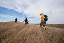 Hikers trek the grasses of Four Canyon Preserve in western Oklahoma as part of a field trip with the Oklahoma chapter of The Nature Conservancy. | Photo Ryan West / The Nature Conservancy / provided