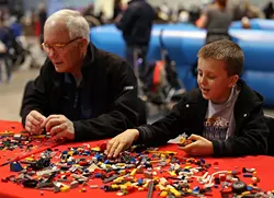 Will Canipe, 8, from Wake Forest, assembles a "car, boat, helicopter, submarine" alongside his grandfather, Giles Jeffreys, from Wendell, during the BrickUniverse Lego Convention at the Raleigh Convention Center on Sunday, March 29, 2015 in Raleigh, N.C. Canine said he plays with legos everyday "except when I'm at Disney World and I'm at the beach." - AL DRAGO