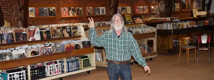 Trolley Stop Record Shop owner John Dunning keeps thousands of vinyl records in stock at his new store location in the old Penn Theater. (Photo Ben Luschen)