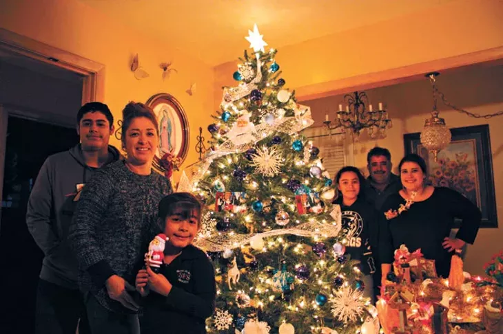 The Chavez family of south Oklahoma City spends Christmas Eve with members of their extended family for a traditional Posada celebration that includes re-enacting Mary and Joseph’s journey to Bethlehem. | Photo Laura Eastes