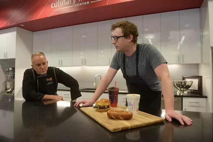 Scott Uehlein, Vice President of Product Development, and Jordan Denton, product developer, talk about some menu items in the works at Sonic's test kitchen, Monday, June 26, 2017. (Garett Fisbeck)