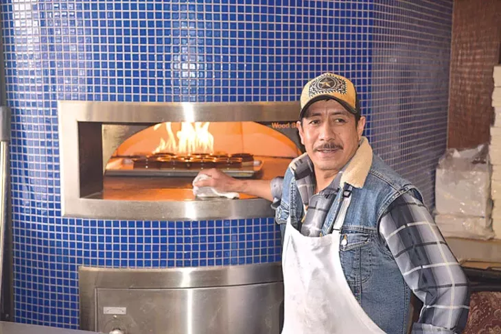 Rodrigo Garcia watches over rice pudding in Fusion’s brick oven. | Photo Jacob Threadgill