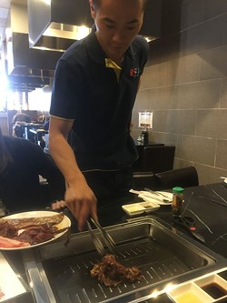 Diners take control of their meal by attending to meat on a sizzling electric grill at Shilla Korean BBQ in Norman. | Photo Jacob Threadgill