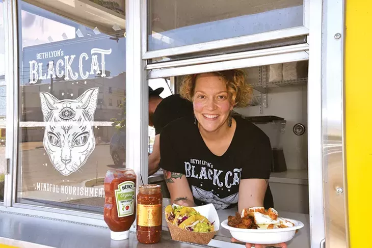 Beth Ann Lyon serves chipotle chicken tacos and the Clucker out of her new Black Cat Food Trailer in Delmar Gardens Food Truck Park. - JACOB THREADGILL