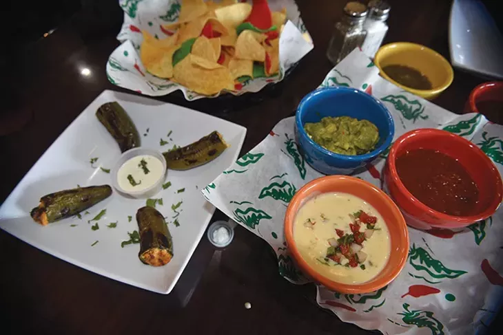 Stuffed jalapeños are joined by queso, guacamole and two salsas. - JACOB THREADGILL