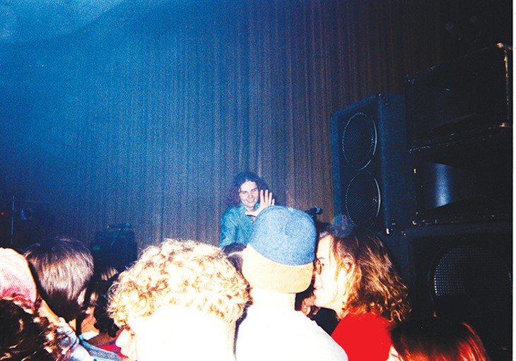 In a Dec. 12, 1991 photo, Billy Corgan of The Smashing Pumpkins smiles at the audience in Norman’s Hollywood Theatre. - BARB HENDRICKSON VEST / PROVIDED