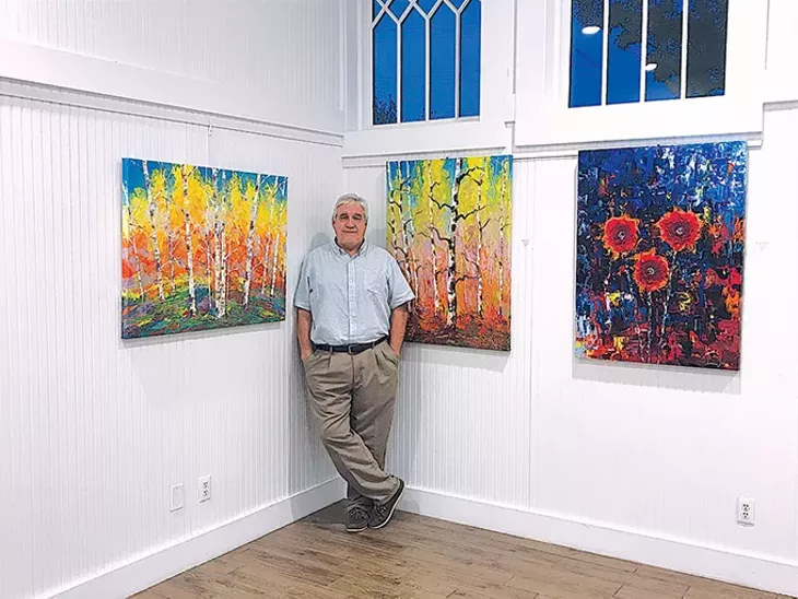 Tim Kenney with a few of his works in the A Burst of Color exhibit at The Depot in Norman. - TIM KENNEY / PROVIDED