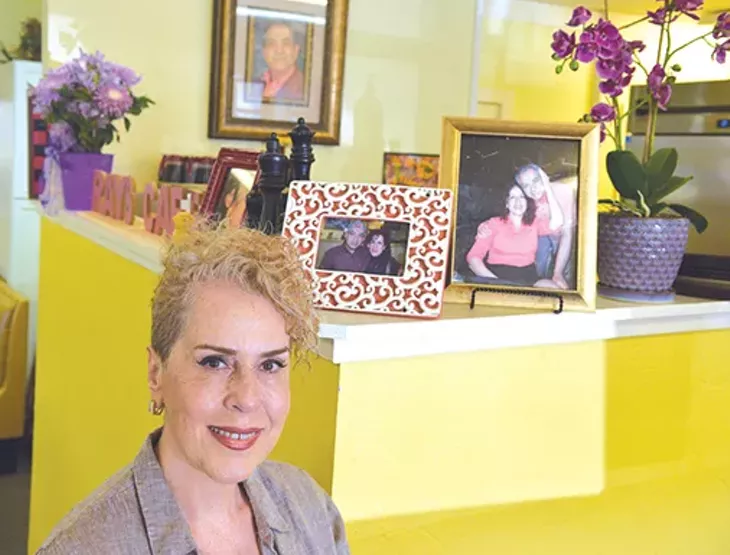 Ray’s Café owner Shermin Khazaeli shares photos of her late husband Reza “Ray” Moeeni. - JACOB THREADGILL